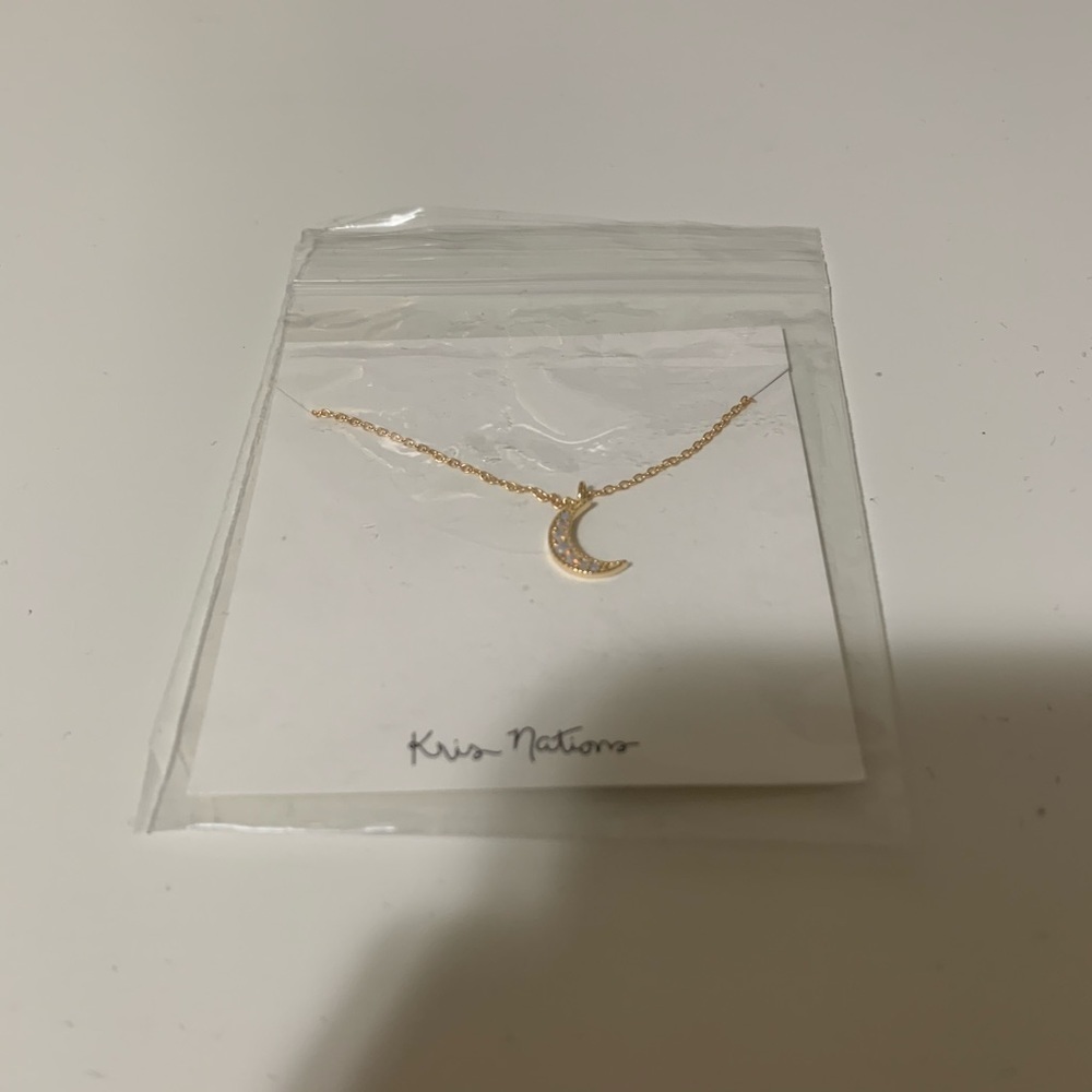 Gold tone kris nations moon necklace